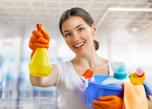 Professional cleaner vacuuming carpets in a home